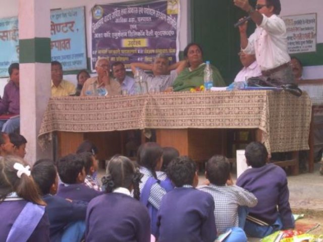 Children facing the guests' table at a school function.