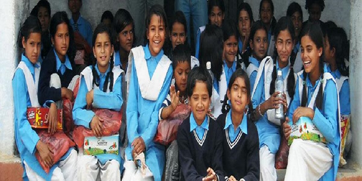 Girls in school uniform seated in rows, each holding a parcel they have been given.