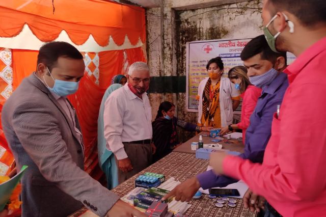 A distribution under the tent at a village programme.