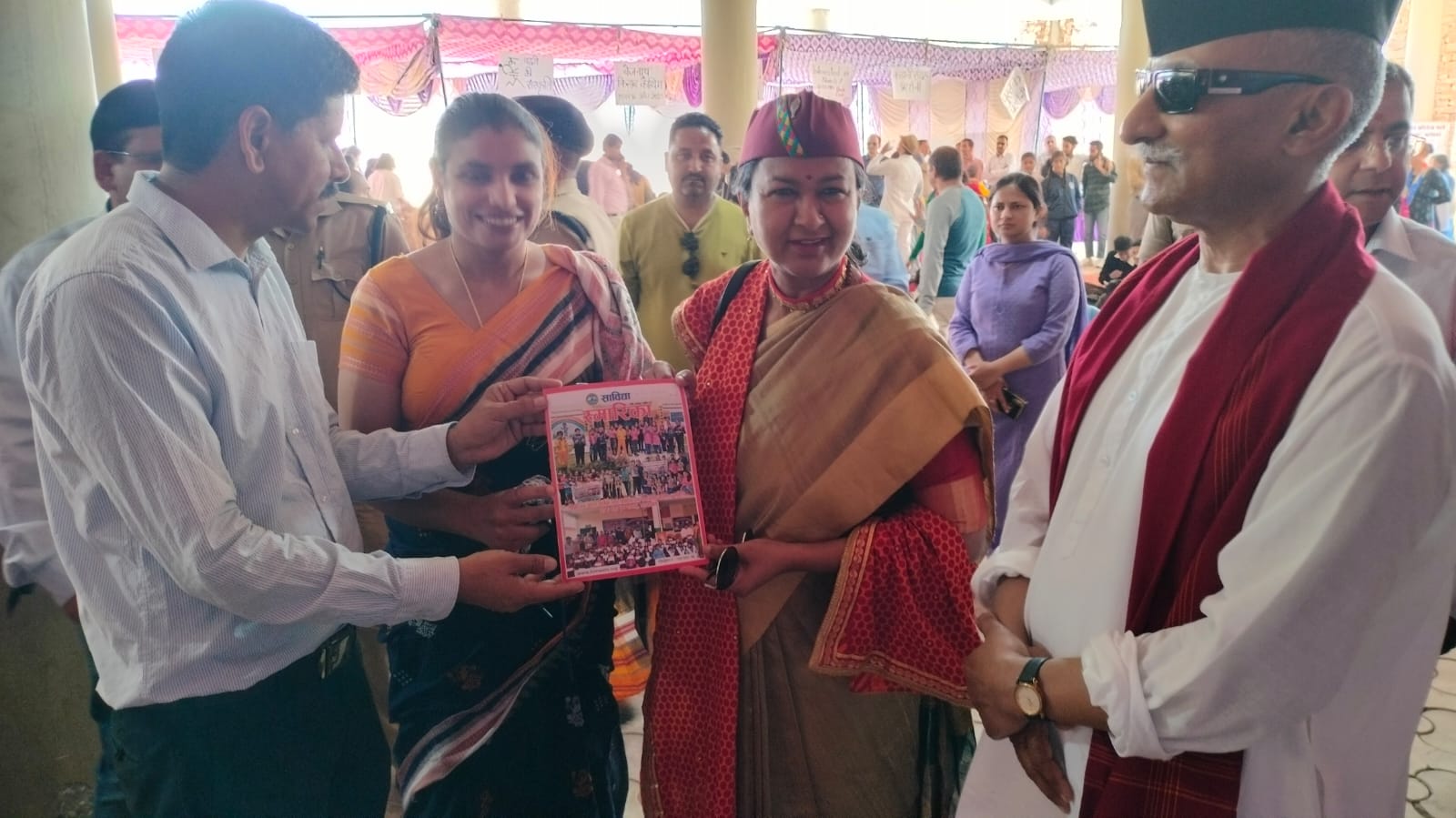 A presentation at the Kitab Kauthig book fair in Berinag, the guests in ceremonial shawls.