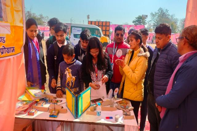 Students crowding round the models on the society's stall at Haldwani.