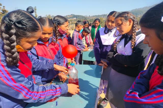 Volunteers and students at a UCOST science fair stall.