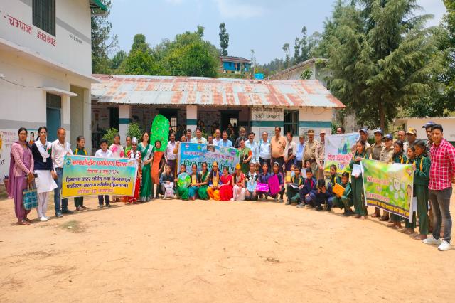 A World Environment Day gathering with banners outside the school.