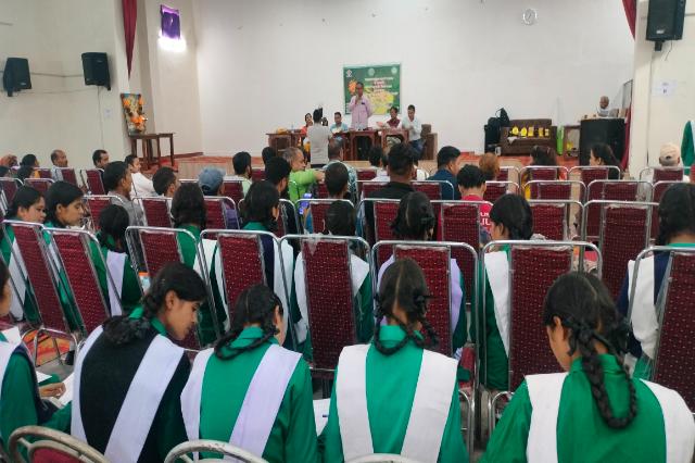 The hall set out with chairs for a summer camp session.