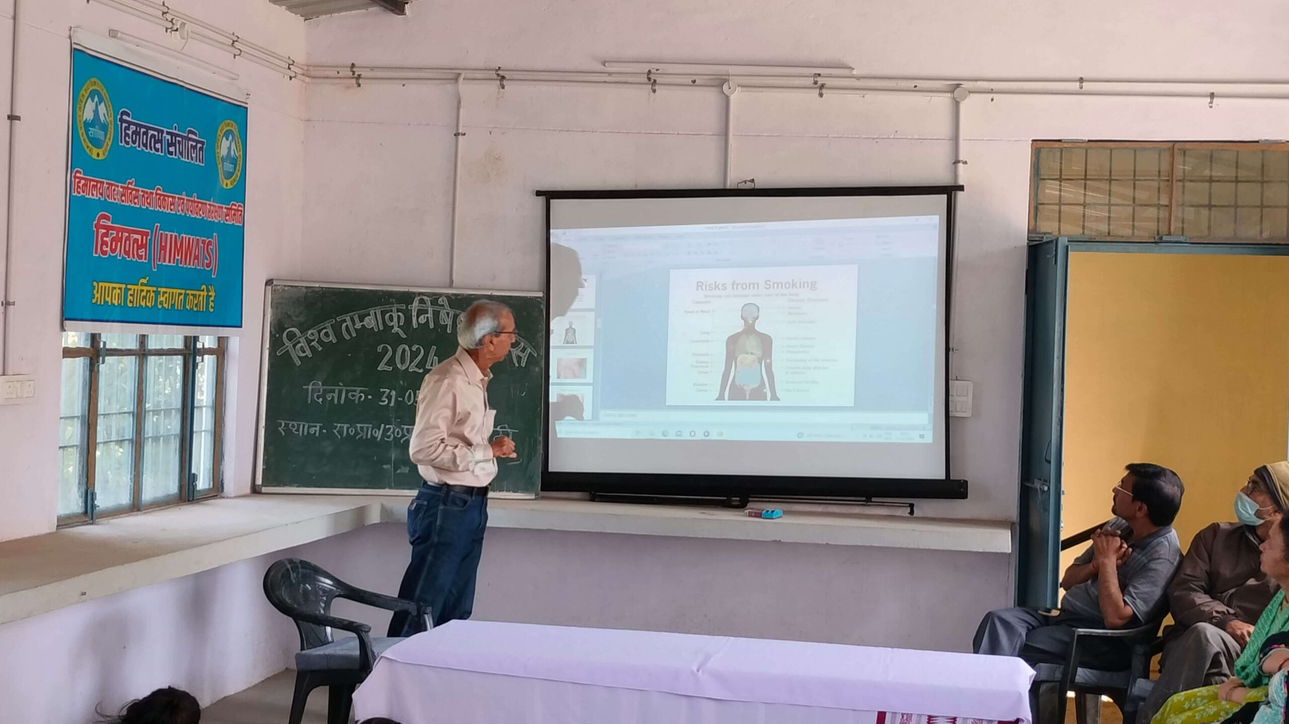 A World Tobacco Day talk, with a diagram of the body's organs projected on the screen.