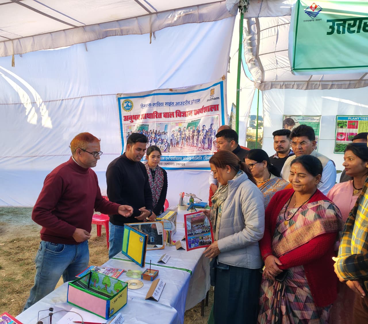 Students and guests at the society’s stall, the exhibits laid out in front of them.