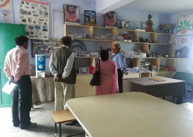 Visitors in the science resource centre, its shelves of models and charts behind them.